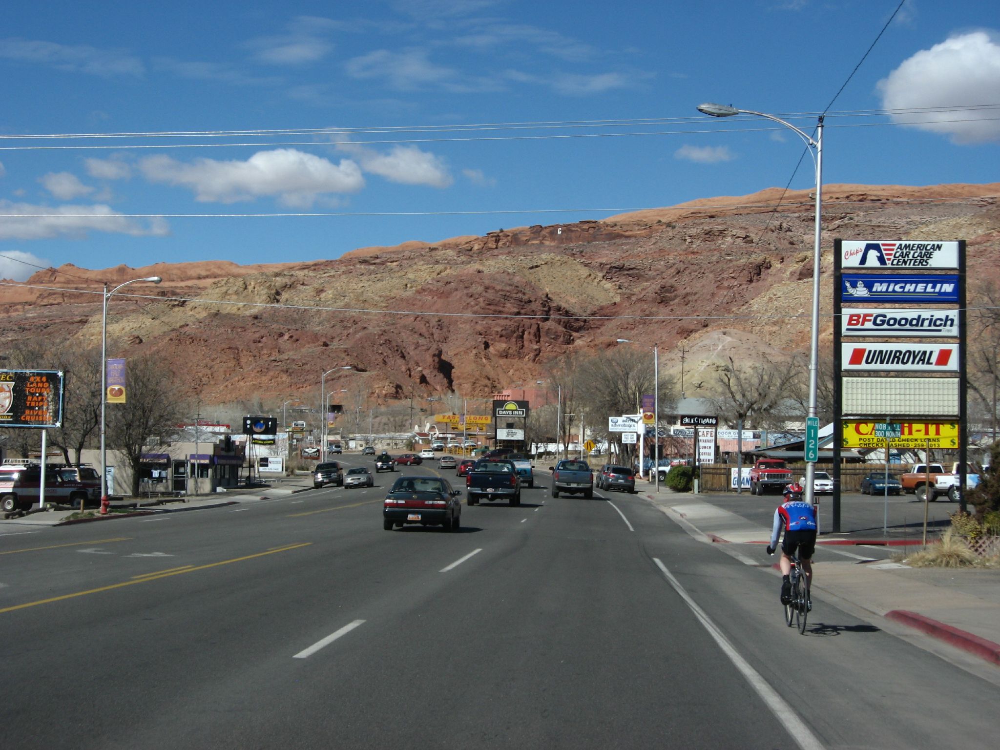 Downtown Moab, Utah, with red rock cliffs beyond